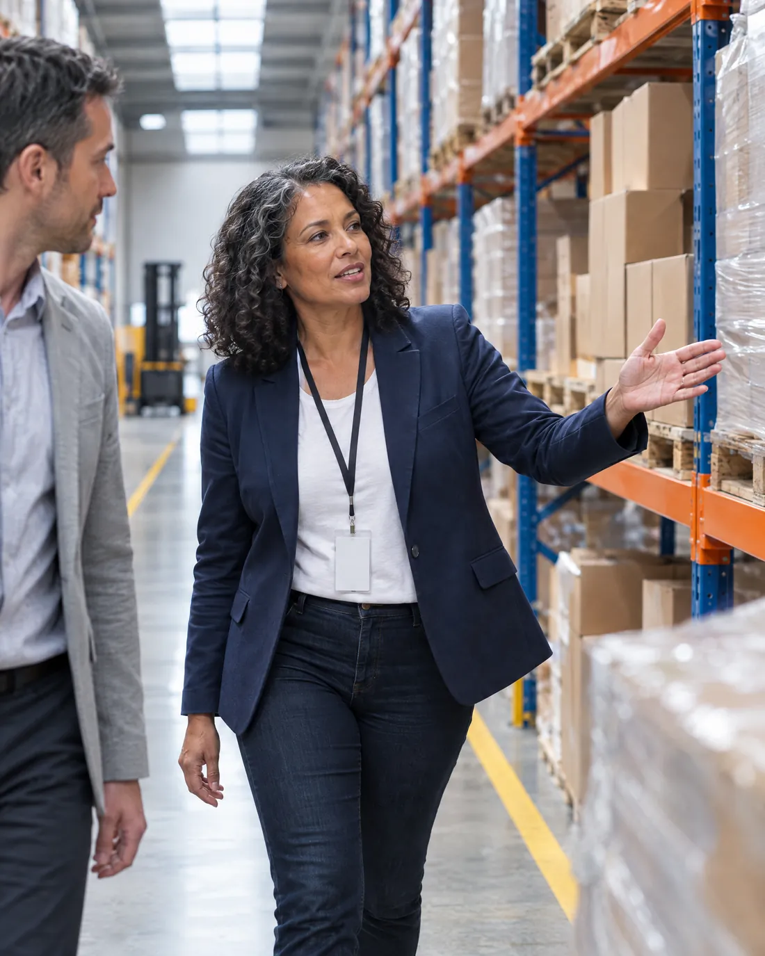 A business owner walking an advisor through her warehouse